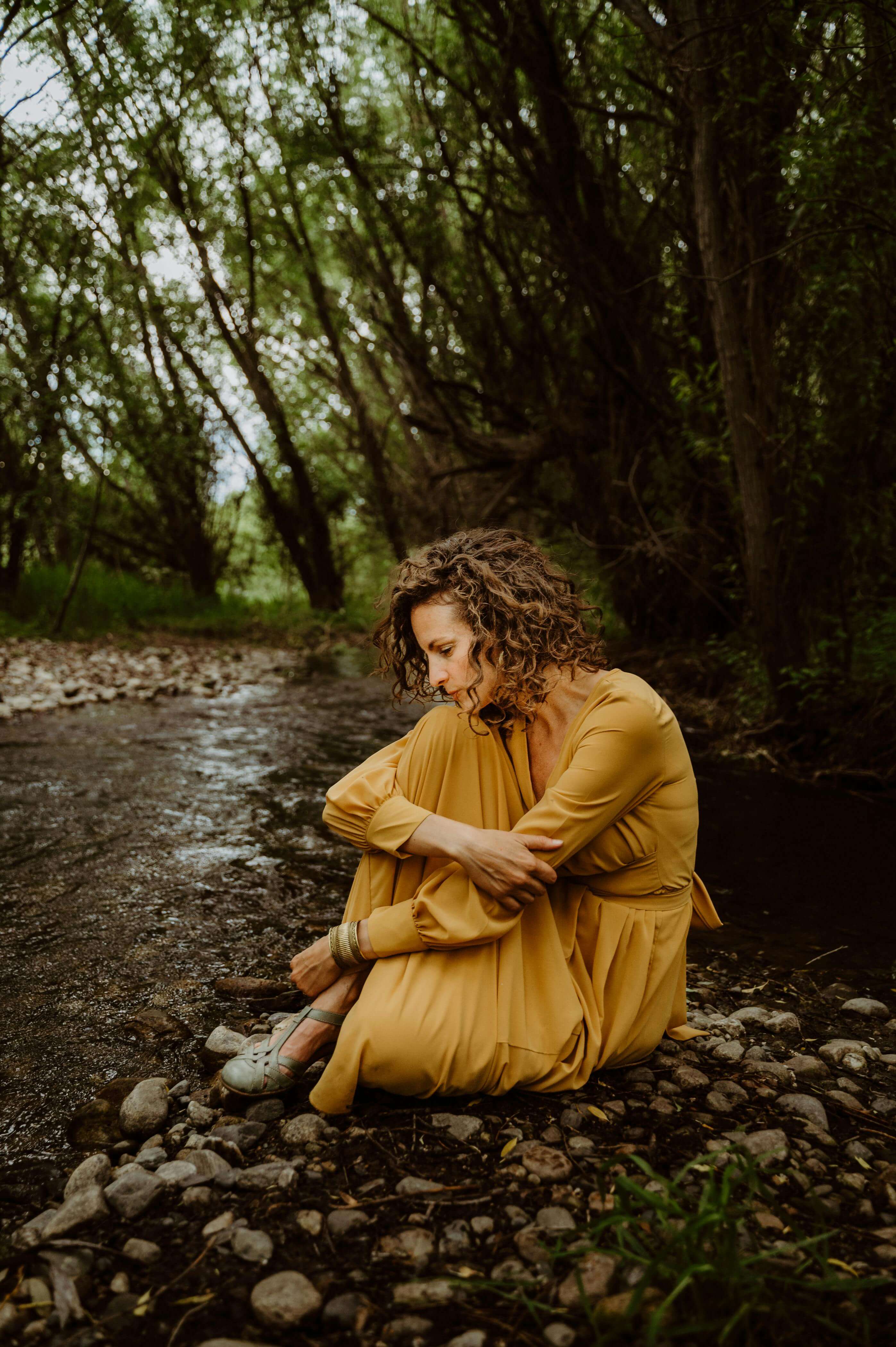 Woman by river in forest